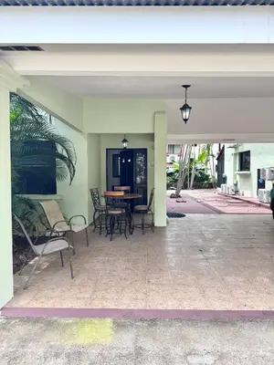 a patio with chairs and a table in a building at Gorgeous Three Bedroom Townhouse in Coco