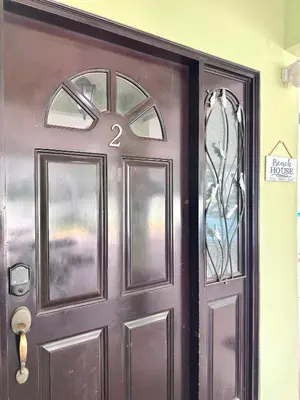 a brown door with a number on it at Gorgeous Three Bedroom Townhouse in Coco