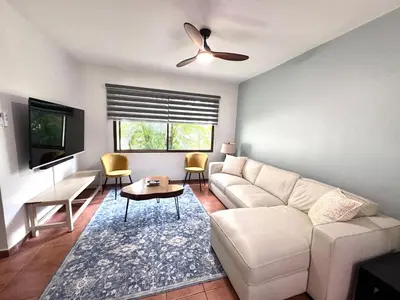 a living room with a couch and a table at Gorgeous Three Bedroom Townhouse in Coco