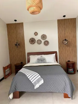 a bedroom with a bed with plates on the wall at Los Guayabos in Sarchí