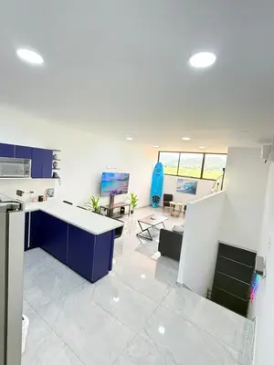 an office with a kitchen with blue cabinets and a desk at Casa Azul Jaco in Jacó
