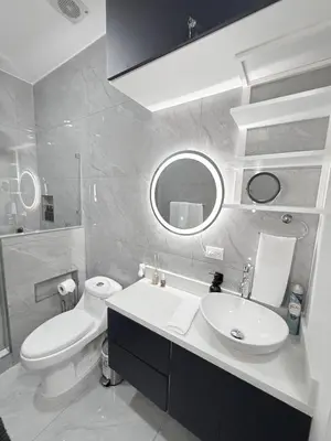 a bathroom with a sink and a toilet and a mirror at Casa Azul Jaco in Jacó