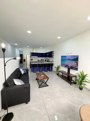 a living room with a couch and a table at Casa Azul Jaco in Jacó