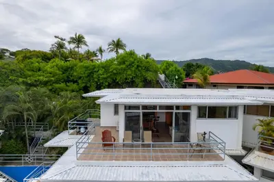 a house with a view of a pool at Modern Top-Floor Condo with Panoramic Views and Community Pool in Coco