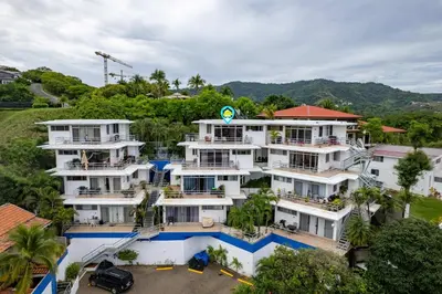 an aerial view of a large white building at Modern Top-Floor Condo with Panoramic Views and Community Pool in Coco