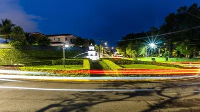 a city street at night with streaks of lights at 31 Studio Apartment in Heredia