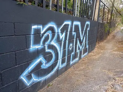 a wall with graffiti on the side of it at 31 Studio Apartment in Heredia