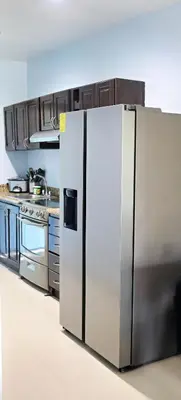 a kitchen with a stainless steel refrigerator at Southern Escapes Apartment in Quepos