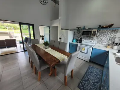 a kitchen with a table and chairs and a kitchen with blue cabinets at Villa María - Perfect Getaway in Fortuna