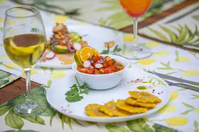 a table with a plate of food and a glass of wine at Villa María - Perfect Getaway in Fortuna