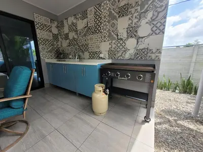 a kitchen with a stove and a chair in it at Villa María - Perfect Getaway in Fortuna