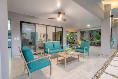 a living room with blue chairs and a table at Villa María - Perfect Getaway in Fortuna
