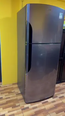a stainless steel refrigerator sitting in a room at The Toucan's House