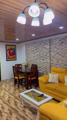 a living room with a couch and a table at The Toucan's House