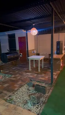 a patio with a white table and a bench at The Toucan's House