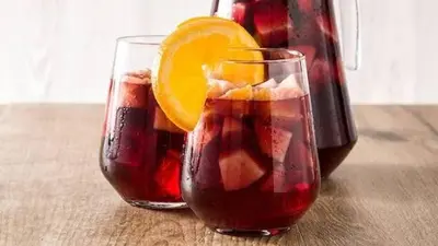 two glasses of sangria next to a bottle of wine at Cabinas Hidalgo in Ojochal
