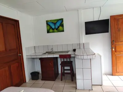 a bathroom with a butterfly hanging on the wall at Cabinas Hidalgo in Ojochal