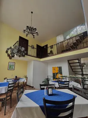a restaurant with tables and chairs and a balcony at Monteverde Ecolodge in Monteverde Costa Rica