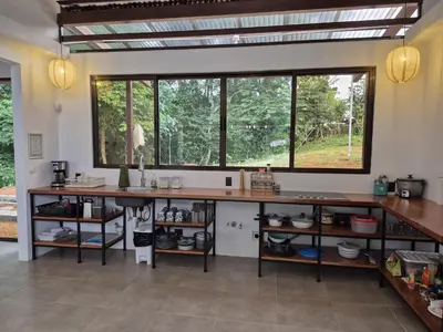 a kitchen with a large window and a large counter at Finca Chavela in Buenos Aires
