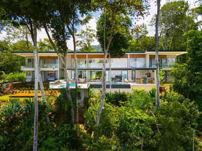an exterior view of a house with trees at Casa LaVista - by Pura Villas in Uvita