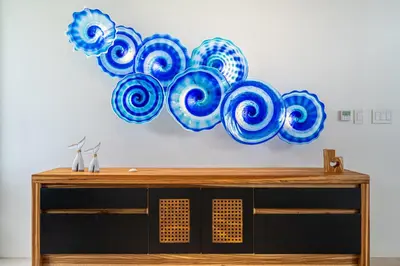 a painting of blue and white plates on a wall at Casa LaVista - by Pura Villas in Uvita