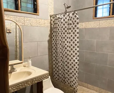 a bathroom with a sink and a shower at Tres Corazones in Carrillo