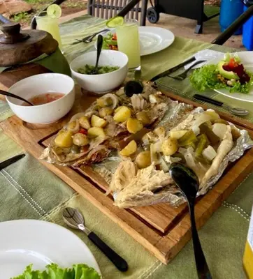 a wooden cutting board with some food on a table at Luxury Villa Ceibo - Exquisite, Private, Serene in San Mateo