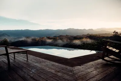 a swimming pool on a deck with a view of the mountains at Luxury Villa Ceibo - Exquisite, Private, Serene in San Mateo