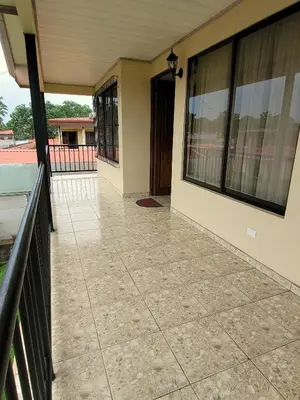 an empty porch of a house with a balcony at Arenal Dreams Apartments in Fortuna