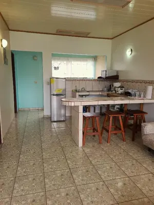 a large kitchen with a table and chairs in it at Arenal Dreams Apartments in Fortuna