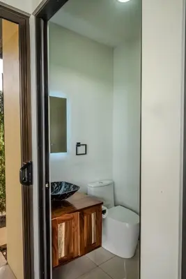 a bathroom with a sink and a toilet at Tree of Heaven Lodge in San Isidro
