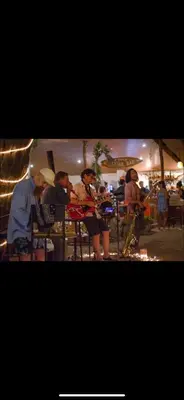 a group of people sitting in chairs at a party at LA DOLCE VITA - on the Beach - Samara in Sámara