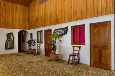 a room with two chairs and a door and some plants at LA DOLCE VITA - on the Beach - Samara in Sámara