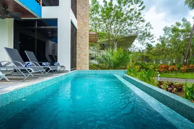 a swimming pool in the backyard of a house at Sleep 11-Beachfront-Pool-Wildlife-100MB -Suites in Parrita
