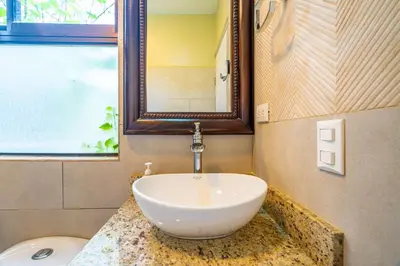 a bathroom with a bowl sink on a counter at Sleep 11-Beachfront-Pool-Wildlife-100MB -Suites in Parrita