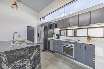 a kitchen with blue cabinets and a counter top at Uvita-Great location-3 bedroom-Private pool-Gated in Uvita
