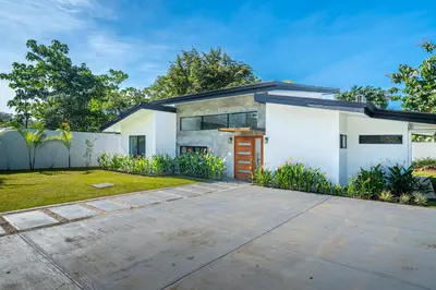 a white house with a driveway at Uvita-Great location-3 bedroom-Private pool-Gated in Uvita