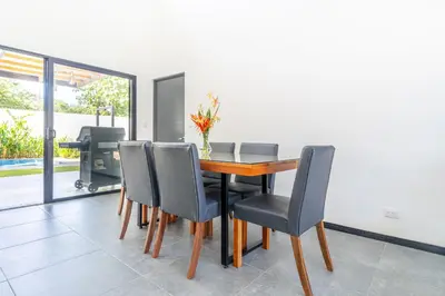 a dining room with a table and chairs at Uvita-Great location-3 bedroom-Private pool-Gated in Uvita
