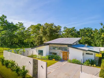 a house with a fence in front of it at Uvita-Great location-3 bedroom-Private pool-Gated in Uvita