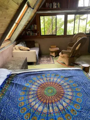a large mandala rug on the floor of a room at Casa Mariposa, Playa Ostional in Nosara