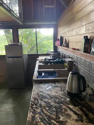 a kitchen with a stove and a refrigerator at Casa Mariposa, Playa Ostional in Nosara