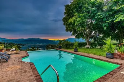 a swimming pool with a view of the mountains at Finca Orgánica Sweet Home Mango in San Mateo