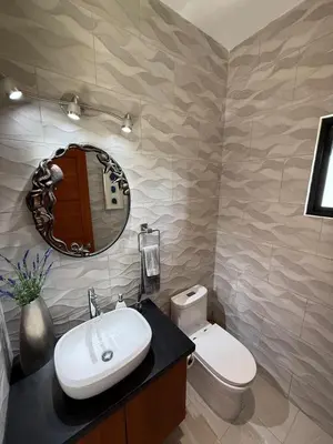 a bathroom with a sink and a toilet and a mirror at Villa Montemar Ocean and Mountain Views Elevated 1200 FT with Wifi in Platanillo