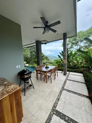 a patio with a table and a grill at Villa Montemar Ocean and Mountain Views Elevated 1200 FT with Wifi in Platanillo
