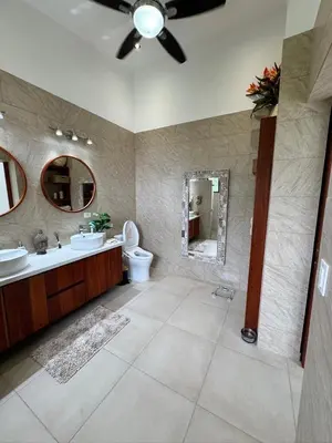 a bathroom with a sink and a toilet and a mirror at Villa Montemar Ocean and Mountain Views Elevated 1200 FT with Wifi in Platanillo