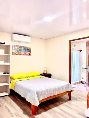 a bedroom with a bed with yellow pillows at Villas Arenal Dreams in Palma