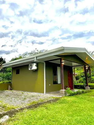a small green house with a roof at Villas Arenal Dreams in Palma
