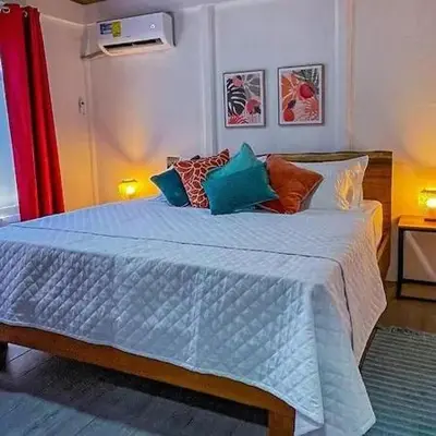 a bedroom with a large bed with pillows at Casa Selva Viva in Uvita