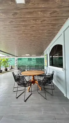 a patio with a table and chairs on a patio at Casa Selva Viva in Uvita