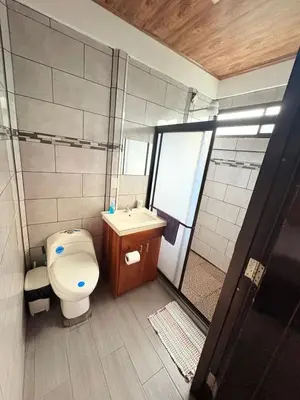 a bathroom with a toilet and a sink and a shower at Casa Selva Viva in Uvita